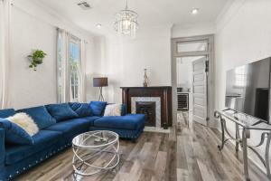 a living room with a blue couch and a fireplace at Spacious Mid City 1BD On The Canal Streetcar Line in New Orleans