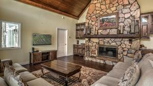 a living room with a large stone fireplace at Jump Right In in Blue Ridge