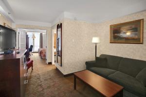 a living room with a couch and a television at Travelodge by Wyndham Lloydminster in Lloydminster