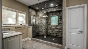 a bathroom with a shower with a stone wall at Jump Right In in Blue Ridge +46 photos