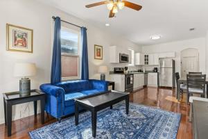 a living room with a blue couch and a table at Pristine and comfy Mid-City 2BD 1BA in New Orleans