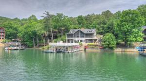 a large house on a river with boats in the water at Jump Right In in Blue Ridge