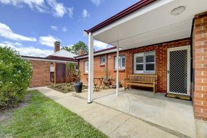 a pavilion with a bench on a patio at Hope St Cottage - Elegant & Cosy, Sleeps 6 in Bathurst