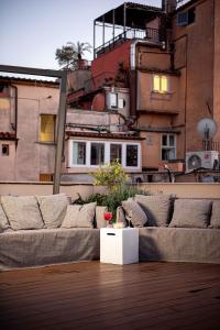 a living room with a couch on top of a building at Nikis Collection Trastevere in Rome