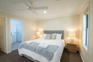 a bedroom with a bed with two towels on it at Regand Retreat - Pool, Luxurious Family Home in Dubbo +14 photos