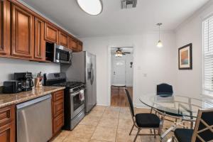 a kitchen with a table and a dining room at 4BD Metairie retreat with driveway and yard in Metairie
