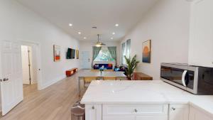 a kitchen and living room with white walls at Sunny 5Bed w Parking and direct Streetcar access in New Orleans