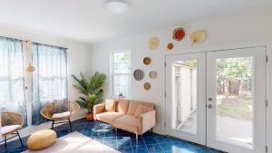 a living room with a chair and a couch at Sunny 5Bed w Parking and direct Streetcar access in New Orleans +24 photos