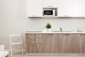 a kitchen with a sink and a microwave at Palazzo Talenti 1907 in Trieste
