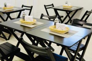 a black table with baskets and napkins on it at GM Hotel SP in Utinga