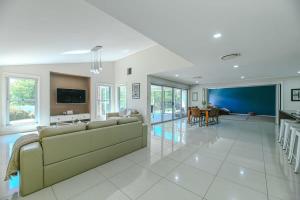 a living room with a couch and a dining room at Southlakes Haven - Lake Views, Pet Friendly in Dubbo
