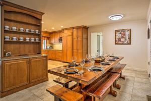 a large kitchen with a long table with wine glasses at Mudge Ranch Retreat near Bass Lake with EV Charger in Coarsegold