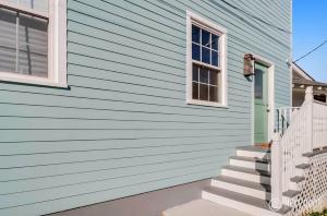 a blue house with stairs and a window at Adorable Treme Nook- Renovated Private Apartment in New Orleans