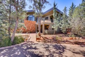 a house in the woods with a driveway at Modern Sedona Guesthouse with Patio, Walk to Trails! in Sedona
