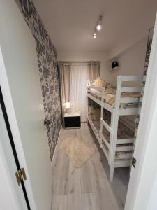 a room with two bunk beds and a hallway at CASA MADRID 2 minutos a la playa in Cullera