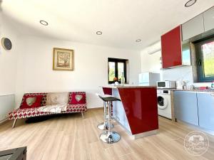 a kitchen and living room with a couch and a table at Pavilhão 1 - Quinta da Prelada Simão in Celorico de Basto