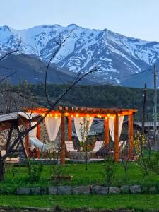 a tent with lights and mountains in the background at Old Tatev Guesthouse in Tatʼev