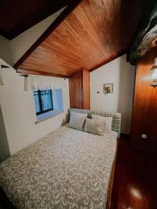 מיטה או מיטות בחדר ב-Cantinho de Aldeias