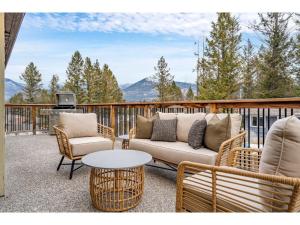 a patio with a couch and chairs and a table at Evergreen Escape I Fireplace I Walk to the Lake in Invermere