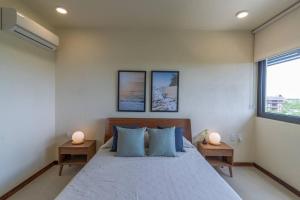 a bedroom with a large bed with two lamps on tables at Stunning Ocean View Penthouse With Private Pool - B301 in Holbox Island +37 photos