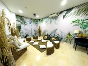 a living room with couches and plants on the wall at Hotel Bolivariana Plaza Medellin in Medellín