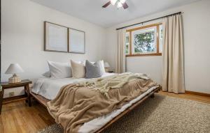 a bedroom with a large bed and a window at The Distillery in Red Deer