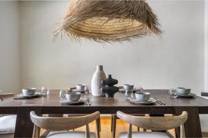 a dining room table with chairs and a wooden table with a basket at The Maverick in Red Deer