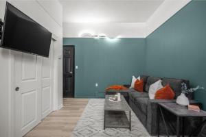 a living room with a couch and a flat screen tv at The Marble in Drumheller