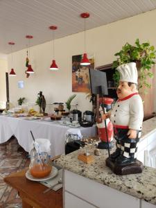 a statue of a chef on a counter in a kitchen at Cambará Suítes in Bonito