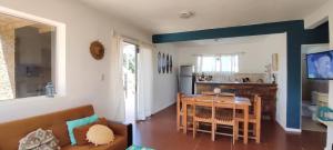 un soggiorno con tavolo e cucina di GreyStone a Balneario Buenos Aires