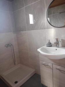 a bathroom with a shower and a sink at Matenia’s house in Mángana