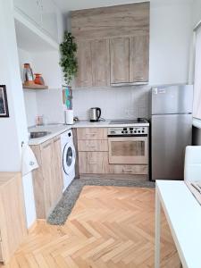 a kitchen with wooden cabinets and a stainless steel refrigerator at Angela's house in Sofia