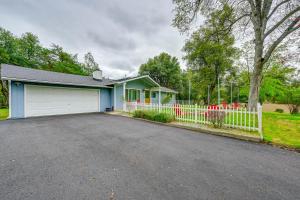 a house with a white fence and a driveway at Dog-Friendly Oakhurst Home Walk to Downtown! in Oakhurst