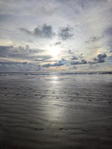 a beach with a cloudy sky and the ocean at Casa Mari - ilha de Algodoal in Algodoal +1 photo