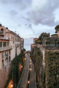 a street with lights on the side of a cliff at BDREAMS APARTAMENT in Castellammare di Stabia