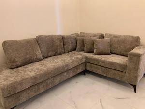 a brown couch sitting in a living room at Salma Suites in Aqaba