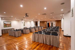 a banquet hall with rows of tables and chairs at Hotel Jose Antonio Cusco in Cusco