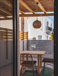 a dining room with a wooden table and chairs at Alonia Suites in Naousa +31 photos