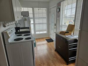 a kitchen with a white stove and a sink at 1609 Esteban St New Orleans/Arabi in Arabi