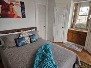 a bedroom with a bed with a blue blanket on it at 1609 Esteban St New Orleans/Arabi in Arabi