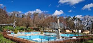 une grande piscine dans un parc arboré dans l'établissement CozyWisi holiday home for 1 to 6 people near Technorama 4 bedrooms 2 bathrooms bookable from 2 days, à Wiesendangen