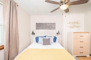 a bedroom with a bed with a ceiling fan at Relax on Ridgeview- 3 bedroom in Appleton