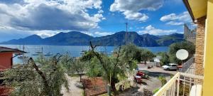 a view of a large body of water with mountains at MariGarda Apartments in Assenza di Brenzone