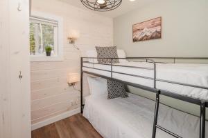 a bedroom with two bunk beds and a window at Cozy Cabin w Fireplace and Sauna in Mountain