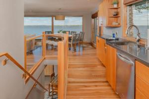 a kitchen with a table and a dining room at Stay at Sunset Shoreline Lakehouse in Oshkosh