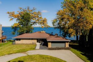 a small house with a lake in the background at Stay at Sunset Shoreline Lakehouse in Oshkosh