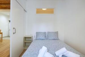 een slaapkamer met een bed met blauwe kussens bij Ro Lively and bright apartment next to Blai st in Barcelona