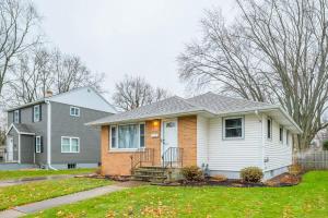 a white house with a gray house at Reed Street Retreat in Green Bay