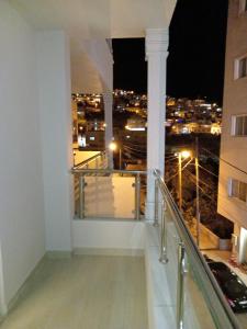 a balcony with a view of the city at night at Petra Premium Hotel in Wadi Musa