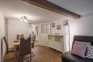 a living room with a table and a dining room at Apartment am schönen Brienzersee in Brienz +18 photos